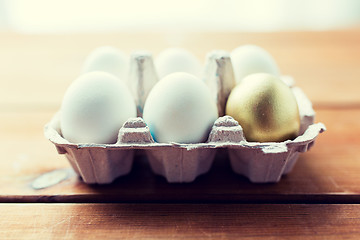 Image showing close up of white and gold eggs in egg box