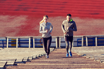 Image showing couple running upstairs on stadium