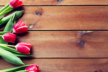 Image showing close up of tulip flowers on wooden table