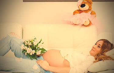 Image showing Pregnant woman with a bouquet of flowers