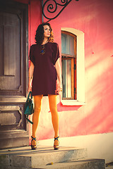 Image showing beautiful woman on the porch of an old building