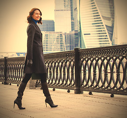 Image showing Smiling handsome entrepreneur in a dark coat