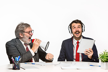 Image showing The two colleagues working together at office on white background.