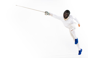 Image showing Man wearing fencing suit practicing with sword against gray