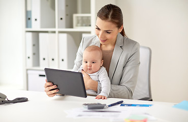 Image showing businesswoman with baby and tablet pc at office