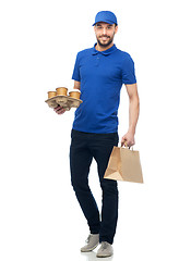 Image showing happy delivery man with coffee and food in bag