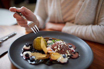 Image showing woman eating ice cream dessert at restaurant