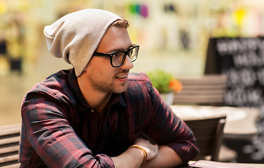 Image showing happy smiling man in eyeglasses and hipster hat