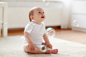 Image showing happy baby with soap bubbles at home