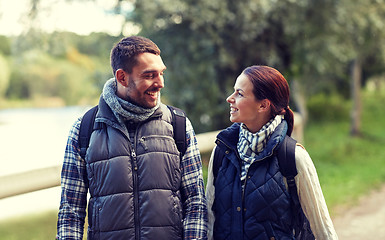 Image showing happy family walking with backpacks in woods