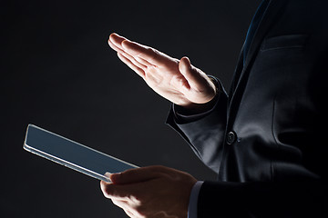 Image showing close up of businessman with transparent tablet pc