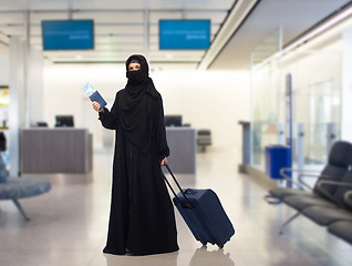 Image showing muslim woman with ticket, passport and travel bag
