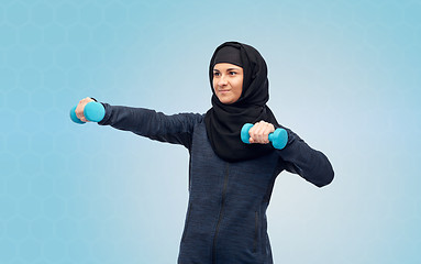 Image showing muslim woman in hijab with dumbbells doing fitness