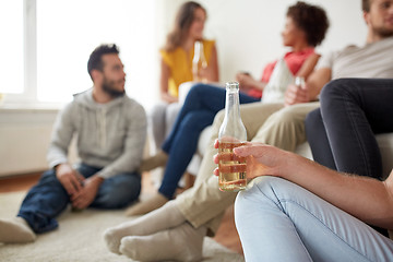 Image showing close up of man with beer bottle and friends