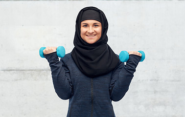 Image showing muslim woman in hijab with dumbbells doing fitness