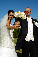 Image showing Wedding couple holding bouquet