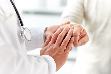 Image showing close up of doctor holding old man hand