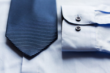 Image showing close up of shirt and blue patterned tie