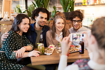 Image showing friends with smartphone photographing at cafe