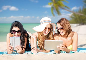 Image showing happy young women with tablet pc on summer beach