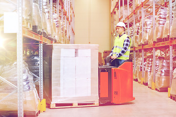 Image showing man on forklift loading boxes at warehouse