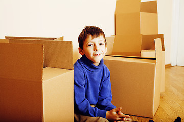 Image showing little cute boy in empty room, remoove to new house. home alone, lifestyle people concept