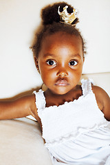 Image showing little pretty african american girl sitting in white chair weari