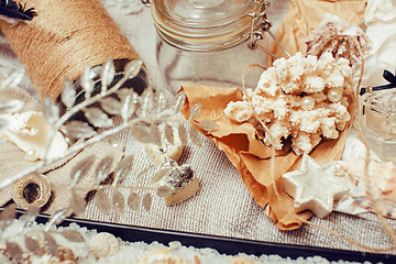 Image showing a lot of sea theme in mess like shells, candles, perfume, girl stuff on linen, pretty textured post card view vintage