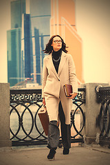 Image showing beautiful business woman in a bright coat