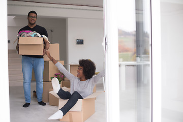 Image showing African American couple  playing with packing material