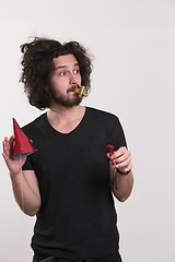 Image showing Portrait of a man in party hat blowing in whistle