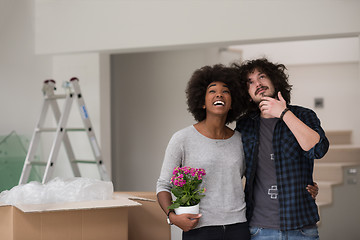 Image showing multiethnic couple moving into a new home