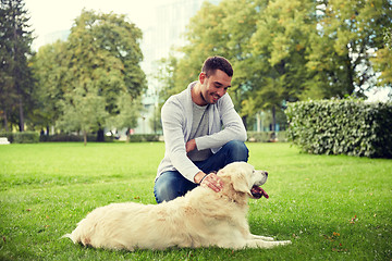 Image showing happy man with labrador dog walking in city