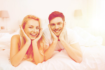 Image showing happy couple lying in bed at home