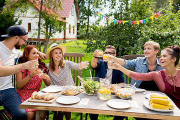 Image showing happy friends having party at summer garden