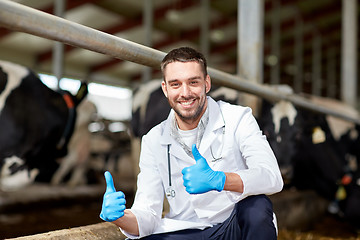 Image showing veterinarian and cows in cowshed on dairy farm