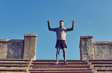 Image showing happy man on stadium stair