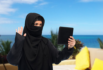 Image showing muslim woman in hijab with tablet pc having chat
