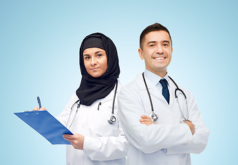 Image showing happy doctors with clipboard and stethoscopes