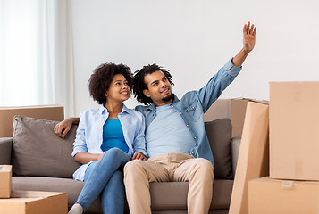 Image showing happy couple with boxes moving to new home