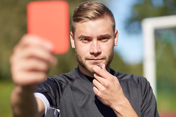 Image showing referee on football field showing red card