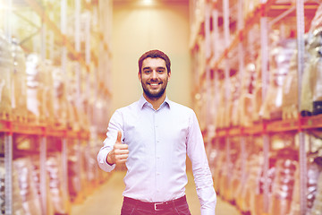 Image showing happy man at warehouse showing thumbs up gesture