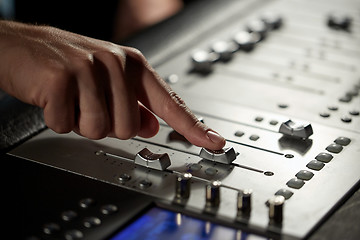 Image showing hand with mixing console in music recording studio