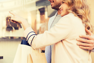 Image showing couple with shopping bags looking at shop window