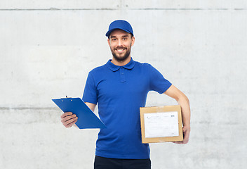 Image showing happy delivery man with parcel box and clipboard