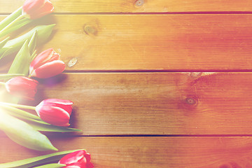 Image showing close up of tulip flowers on wooden table