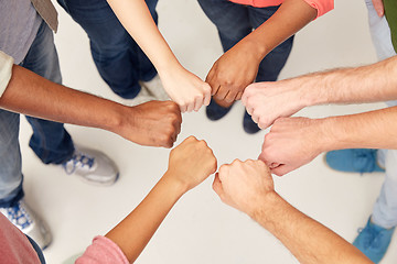 Image showing hands of international people making fist bump