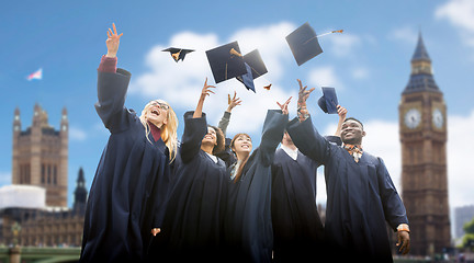 Image showing happy students throwing mortarboards up