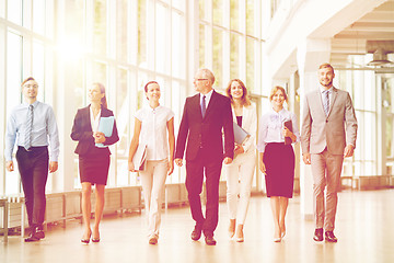 Image showing business people walking along office building