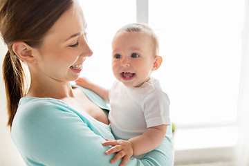 Image showing happy young mother with little baby at home